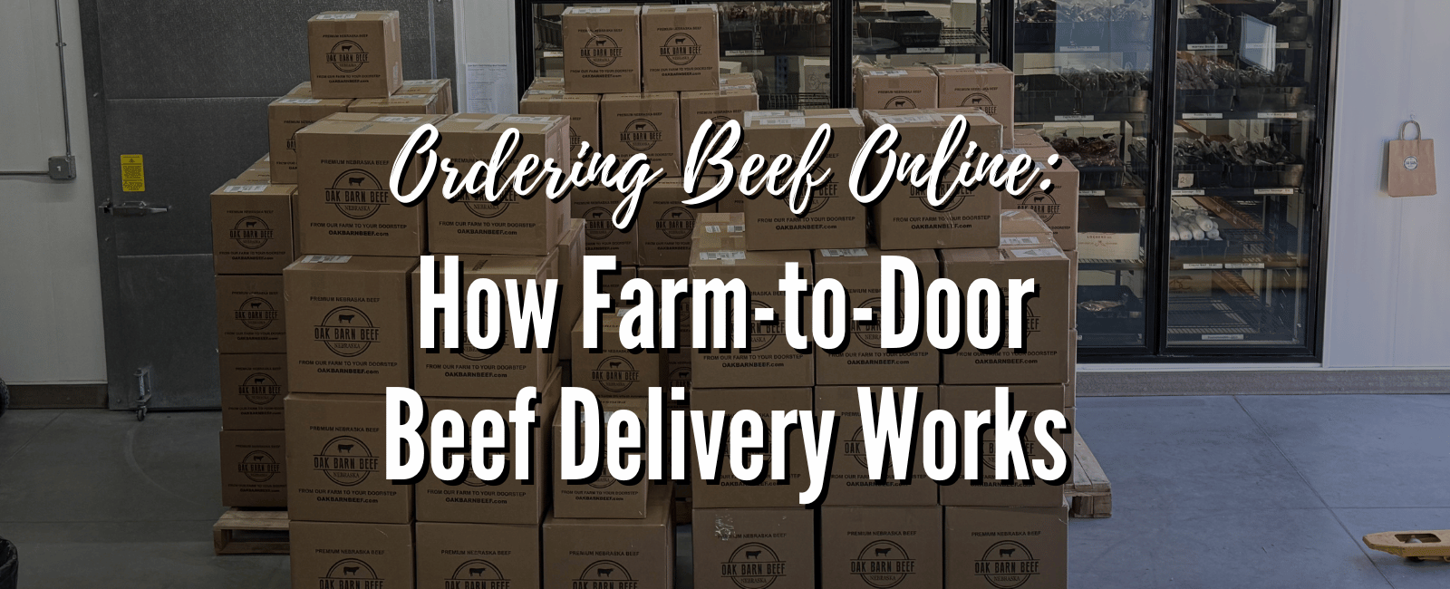 Stacks of Oak Barn Beef shipping boxes in a cold storage room with text overlay: Ordering Beef Online – How Farm-to-Door Beef Delivery Works.