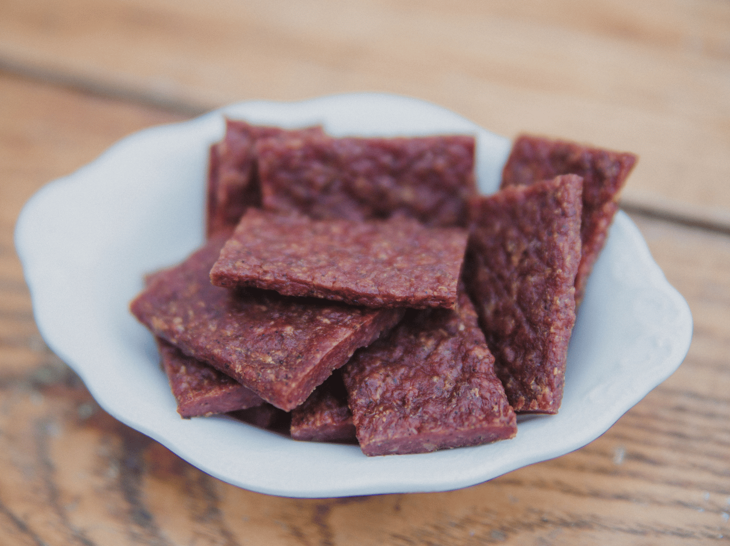 Nebraska Beef Jerky in a white bowl on a wood table